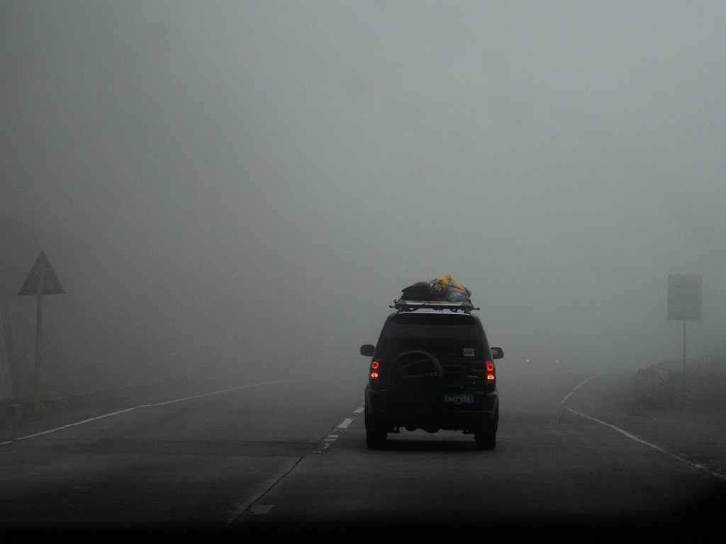 A lone car driving through the Baguio Fog. Image via Flickr