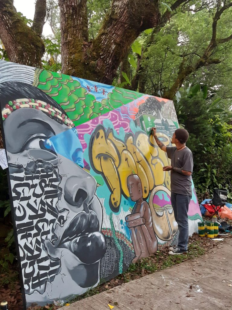 Photo of a street mural in progress from IBAGIW 2019 opening