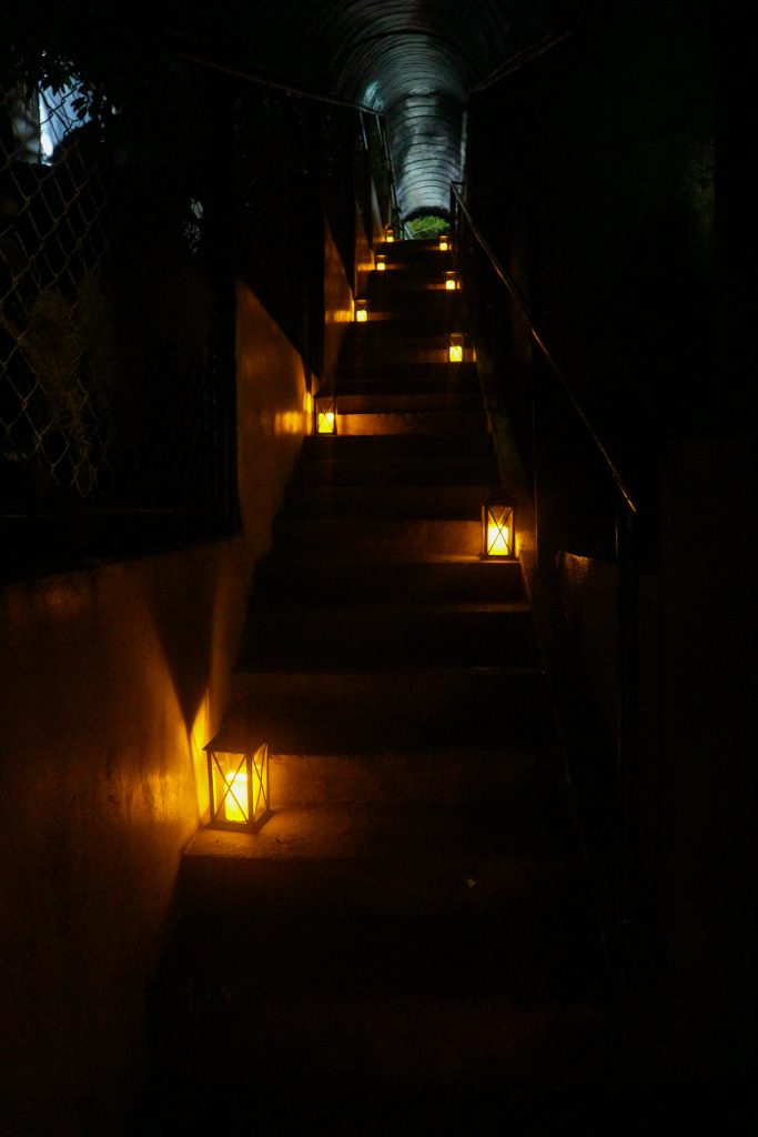 Lanterns light the darkened entry passageway towards The Mystery Cafe